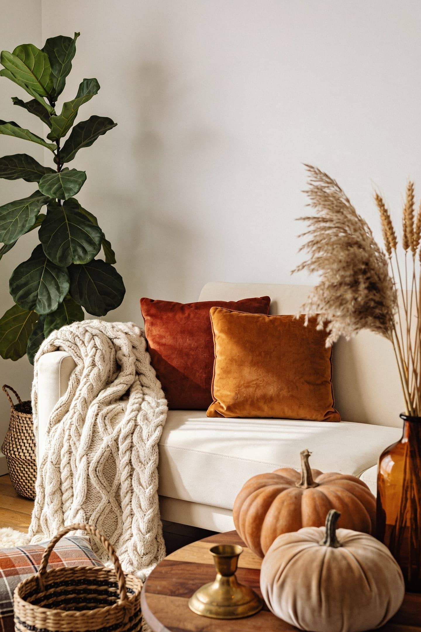 cozy fall living room with a chunky throw, warm lamplight and dried stems